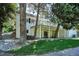 Charming home exterior featuring a cozy back porch, lush greenery, and wooded surroundings at 4675 S Yosemite St # 205, Denver, CO 80237