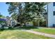 Lovely backyard with mature trees and a paved path in a well maintained outdoor space at 4675 S Yosemite St # 205, Denver, CO 80237
