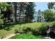 Expansive backyard featuring a lush green lawn, a picturesque pond, and multiple outdoor living spaces at 4675 S Yosemite St # 205, Denver, CO 80237