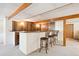 Finished basement featuring a dry bar with seating, wood-paneled walls, and carpet flooring at 4675 S Yosemite St # 205, Denver, CO 80237