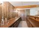 Finished basement featuring a dry bar with wooden countertop and paneled walls at 4675 S Yosemite St # 205, Denver, CO 80237