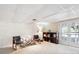Cozy basement sitting area with a pair of chairs, small table, and shelving unit in the corner at 4675 S Yosemite St # 205, Denver, CO 80237