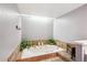 Large tub with plants, white walls, and skylight at 4675 S Yosemite St # 205, Denver, CO 80237