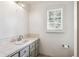 Bathroom featuring a single sink vanity with white countertop, gray cabinets, and bright natural light at 4675 S Yosemite St # 205, Denver, CO 80237