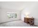 Bright bedroom featuring natural light from large windows, a neutral color palette, and vaulted ceilings at 4675 S Yosemite St # 205, Denver, CO 80237