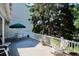 Relaxing deck with white railing, patio furniture, and lush greenery provides a serene outdoor living space for enjoyment at 4675 S Yosemite St # 205, Denver, CO 80237