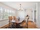 Inviting dining room featuring shuttered windows, wood floors, and a classic chandelier for an elegant dining experience at 4675 S Yosemite St # 205, Denver, CO 80237