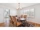 Elegant dining room featuring a chandelier, large windows, and hardwood flooring at 4675 S Yosemite St # 205, Denver, CO 80237