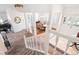 Open entryway leads to a dining room and living room, featuring a piano and staircase at 4675 S Yosemite St # 205, Denver, CO 80237