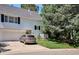 Charming home exterior with white siding, a gray roof, and a well-manicured front lawn at 4675 S Yosemite St # 205, Denver, CO 80237