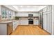 Well-maintained kitchen offers bright white cabinetry, stainless appliances, and hardwood floors for an efficient cooking space at 4675 S Yosemite St # 205, Denver, CO 80237