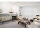 Cozy living room features a stone fireplace, built-in shelving, and plush carpeting, perfect for relaxation and entertaining at 4675 S Yosemite St # 205, Denver, CO 80237
