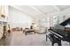 Spacious living room featuring a piano, fireplace, and bright windows, creating a welcoming and comfortable atmosphere at 4675 S Yosemite St # 205, Denver, CO 80237