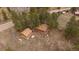 An aerial view of the cabin and property featuring mature trees at 27888 Richmond Hill Rd, Conifer, CO 80433
