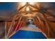 Large attic space with exposed wooden beams, offering potential for storage or conversion into a unique living area at 27888 Richmond Hill Rd, Conifer, CO 80433
