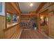Inviting entryway featuring wood paneling, a window seat, and a view into the cozy living room at 27888 Richmond Hill Rd, Conifer, CO 80433