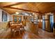 Bright kitchen with island, stainless steel appliances, wood cabinets, and adjacent dining area with forest views at 27888 Richmond Hill Rd, Conifer, CO 80433