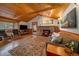 Inviting living room featuring a stone fireplace, hardwood floors, and comfortable seating arrangements at 27888 Richmond Hill Rd, Conifer, CO 80433