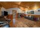 Inviting living room features a stone fireplace, wood-paneled walls and ceilings, and comfortable seating at 27888 Richmond Hill Rd, Conifer, CO 80433