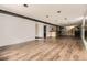 Spacious basement area with hardwood flooring and a bar at 31168 Witteman Rd, Conifer, CO 80433