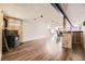 Spacious basement with wood-burning stove, wood flooring, and bar at 31168 Witteman Rd, Conifer, CO 80433