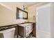 Bathroom featuring marble sink and an ornate framed mirror at 31168 Witteman Rd, Conifer, CO 80433