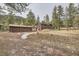 Charming single-Gathering home featuring wooden accents and a detached two-car garage in a serene, wooded setting at 31168 Witteman Rd, Conifer, CO 80433