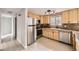 A kitchen with stainless steel appliances, light wood cabinets, and a window overlooking the trees at 31168 Witteman Rd, Conifer, CO 80433