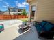 Backyard patio features a wicker sofa with plush blue cushions and a decorative glass-topped table at 425 W 128Th Dr, Westminster, CO 80234