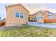 Tan house with a large backyard, patio, and grassy area at 425 W 128Th Dr, Westminster, CO 80234