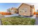 Tan house with a large backyard, patio, and grassy area at 425 W 128Th Dr, Westminster, CO 80234