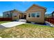Spacious backyard with a concrete patio, grass area, and well-maintained landscaping at 425 W 128Th Dr, Westminster, CO 80234