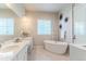 Elegant bathroom with a soaking tub, double vanity, and modern fixtures at 425 W 128Th Dr, Westminster, CO 80234