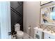 Modern powder room with a geometric wall design at 425 W 128Th Dr, Westminster, CO 80234