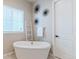 Relaxing bathroom with a freestanding soaking tub and window at 425 W 128Th Dr, Westminster, CO 80234