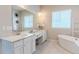 Bright bathroom featuring a double vanity, soaking tub, and stylish accents at 425 W 128Th Dr, Westminster, CO 80234