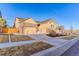 Brick and beige two-story home with attached garage and landscaped yard at 425 W 128Th Dr, Westminster, CO 80234