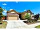 Inviting home with a three-car garage, brick accents, and a landscaped yard under a bright blue sky at 425 W 128Th Dr, Westminster, CO 80234