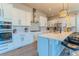 Modern kitchen with white cabinets, stainless steel appliances, and an island with seating at 425 W 128Th Dr, Westminster, CO 80234