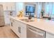 Modern kitchen island with double sink, quartz countertop, and stainless steel dishwasher at 425 W 128Th Dr, Westminster, CO 80234