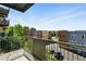 Scenic balcony view overlooking a vibrant neighborhood with colorful buildings and lush trees at 7931 W 55Th Ave # 105, Arvada, CO 80002