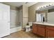 Well-lit bathroom includes a tub-shower combo, vanity with storage, and tile flooring at 7931 W 55Th Ave # 105, Arvada, CO 80002