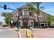 Well-maintained building exterior with stylish signage, modern lighting, and outdoor dining area at 7931 W 55Th Ave # 105, Arvada, CO 80002
