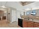Bright kitchen features stainless steel appliances, wood cabinetry, and easy access to the bathroom and living area at 7931 W 55Th Ave # 105, Arvada, CO 80002
