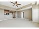 The living room is spacious with an open concept floor plan into the kitchen area, featuring ceiling fan at 7931 W 55Th Ave # 105, Arvada, CO 80002