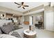 Open-concept living room with a ceiling fan, dining area, and view into the kitchen, creating a welcoming space at 7931 W 55Th Ave # 105, Arvada, CO 80002