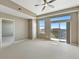 Bright and airy living room with access to a balcony, large windows, and neutral-toned walls at 7931 W 55Th Ave # 105, Arvada, CO 80002