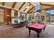 Inviting lounge with a cozy fireplace, billiards table, comfortable seating, and large windows for natural light at 7931 W 55Th Ave # 105, Arvada, CO 80002