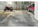 Designated parking spot in a secure garage, featuring a motorcycle and car at 7931 W 55Th Ave # 105, Arvada, CO 80002