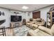 Cozy basement featuring a large sectional with a rustic entertainment center and a wet bar at 11769 Lovegrass Dr, Parker, CO 80138